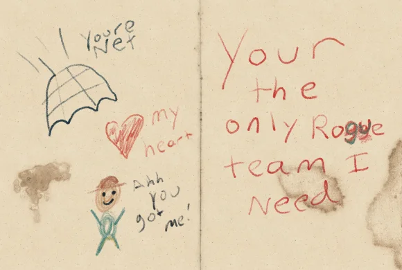 An open crayon Valentine showing an umbrella, a heart, and small figures beside a joke about a rogue team.